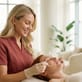 Esthetician applying a retinoid-based serum to a client’s face during a professional skincare treatment in a bright spa.