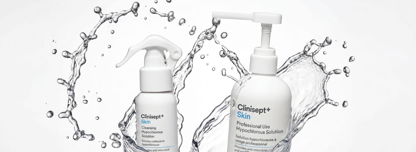 Clinisept+ Skin hypochlorous solution: travel-size spray and professional pump bottle with a dynamic water splash on a clean white background